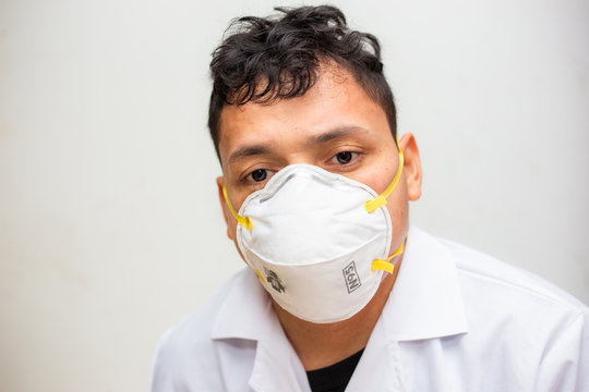 Young Asian Man Wear N95 Mask Protect Dusk And COVID 19 On White Background