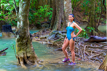 Woman in swimsuit pretty at Huai Mae Khamin waterfall and natural