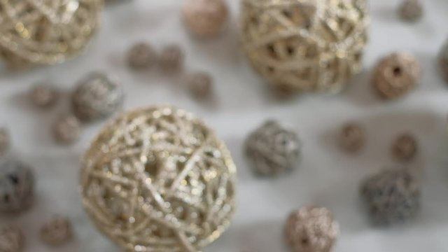 Christmas composition. Golden vine balls. 4K resolution dolly shot. Shallow depth of field.