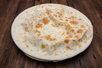 Seafood spaghetti with mussels in the dough on a wooden table.
