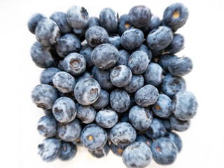 a bunch of natural real blueberries on a white background. radial blur, top view