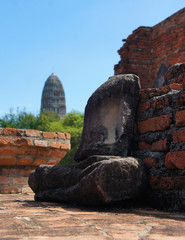 Torso of Meditating Buddha with Prang in Distance