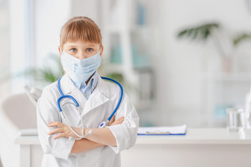 Cute little doctor in clinic