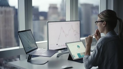 Skilled female marketer with electronic stylus analyzing commerce data infographics during work with online platform blockchain, professional woman reading diagram info about bitcoin crypto currency
 - Powered by Adobe