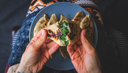 Homemade baked bread. Pie with potato and green spinach. Pirozhki - Russian traditional baked small...