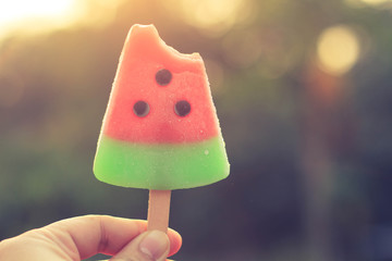 Hand hold watermelon popsicle. With blurred background.