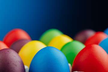 Fototapeta na wymiar Easter festive multicolor eggs, blue background