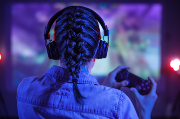 Girl plays online computer games with gamers. Gaming communication. Arcade, racing, shooting,...