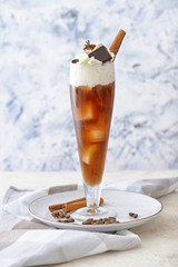 Glass of tasty iced coffee on table