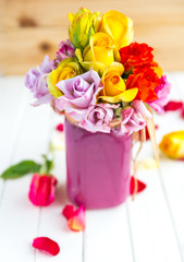 Colorful roses put in the purple vase or flowerpot
