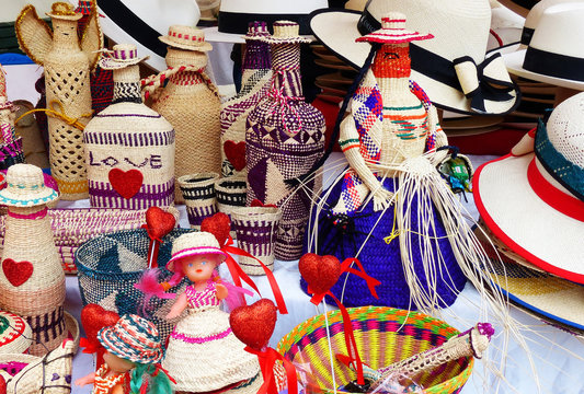 Wicker souvenirs: baskets, dolls, bottles, vases, hats made from toquilla straw, vegetable fiber and painted with various colors at artisan market in Cuenca, Ecuador