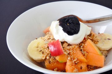 Healthy fresh fruit cereal and Greek yogurt served in a bowl for breakfast