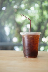 Glass of refreshing soda drink with ice cubes and straw