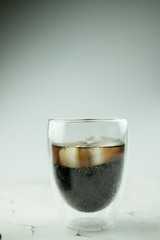 Glass of refreshing soda drink with ice cubes