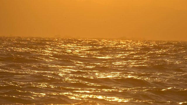 Rough sea waves at sunset