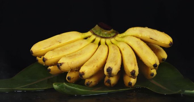 A bunch of bananas on the leaves with cool steam.