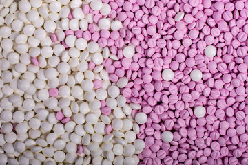 medicines background macro pink and white. Drugs, painkillers, colds other pills
