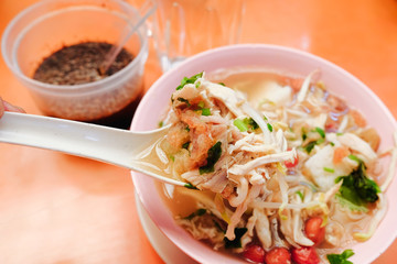 Bone marrow soup also known as soup gear box.served in a pink bowl.