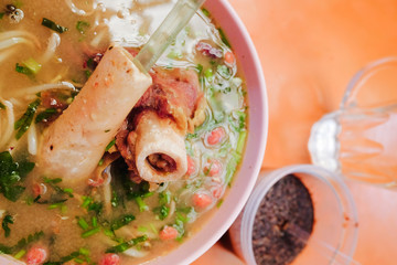 Bone marrow soup also known as soup gear box.served in a pink bowl.