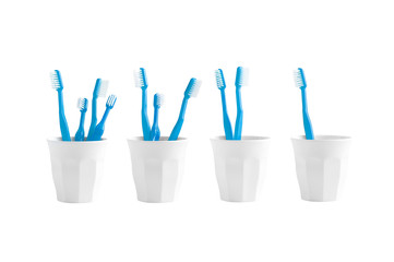 Group of toothbrush in a plastic cup isolated on white background, plastic toothbruch on white background