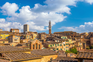 Fototapeta na wymiar Downtown Siena skyline in Italy with blue sky