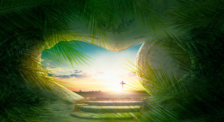 Palm Sunday concept: green palm tree leaves on cross sunset background