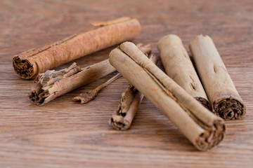 Cinnamon sticks on a wooden background.