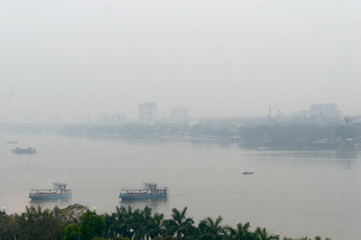 Panoramic Kolkata riverside city life in a winner foggy evening. Ariel view Kolkata in Hooghly riverbank West Bengal India South Asia Pacific. Photography from rooftop.