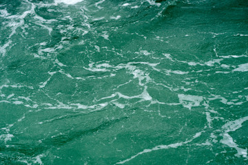 Waves on the green ocean water. Abstract nature background.