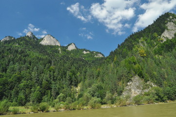 Bald mountain tops, Three Crowns in the Pieniny National Park in Poland. View from the Dunajec riverbed during rafting with rafts.rafting with rafts.