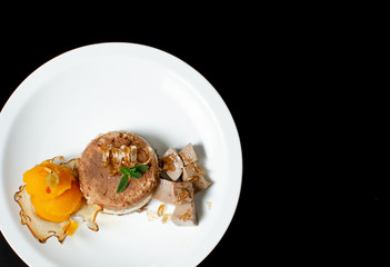 desserts on black background in white plate