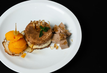 desserts on black background in white plate