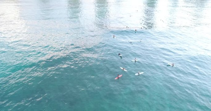 Aerial view, surfers off the coast of Philippines, in deep blue water