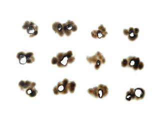 Collection of burnt holes in a piece of paper isolated on white background. Fire holes in white paper.