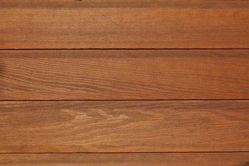 texture of wood planks coated with glaze. color similar to chestnut, teak, walnut or oak. May be suitable for advertising protective wood coatings