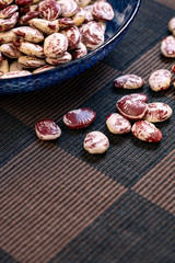 A Bowl Of The Flower Bean And Some Flower Bean On The Checks Table Mat 
