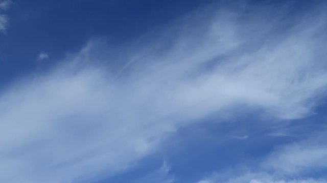 Beautiful white smoky fluffy cirrus & cumulus clouds on tropical summer or spring bright blue sky background in sunny day TimpLapse for transitional & meditative motion vdo or nature related project