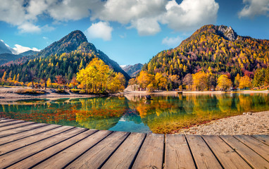 Bright autumn day on the shore of the Jasna lake. Stunning summer scene of Julian Alps, Gozd...