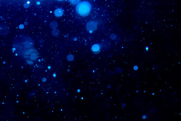 Obraz na płótnie Canvas Blur blue bokeh of light on black