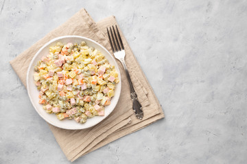 Russian salad Olivier with mayonnaise on plate. Above view. Copy space for text.