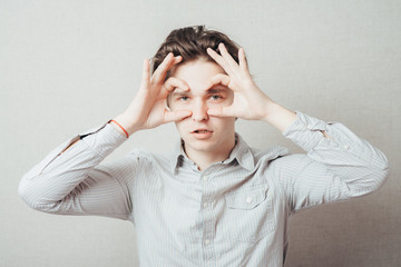 young man showing binoculars