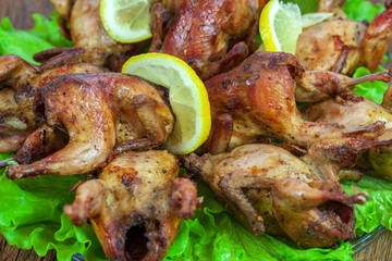 Fried quail in the orange with tomato and fresh parsley and spices