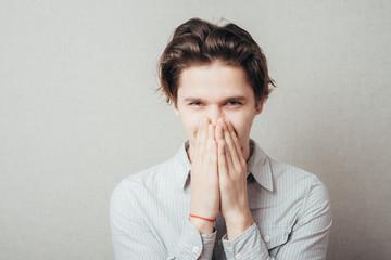 A young man holding back vulgar jokes