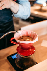 preparing a pourover (v60) in coffeeshop