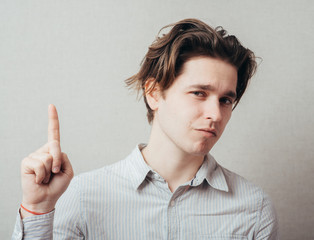 man pointing up with his index finger