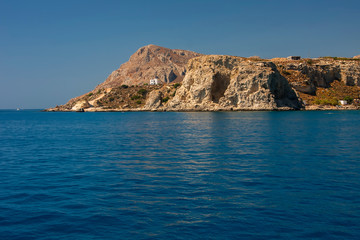 Fototapeta na wymiar Beautiful stone mountain on the shore of the blue sea