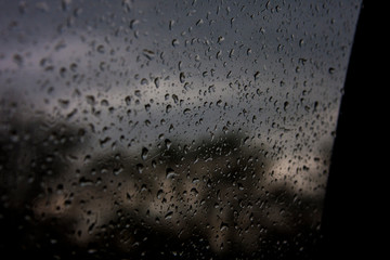 Splashing on glass against a gloomy gray sky