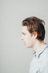 Close up portrait of teen showing Side face view and surprised face expression