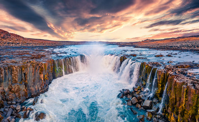 View from flying drone of Selfoss Waterfall. Awesome summer sunrise on Jokulsa a Fjollum river, Jokulsargljufur National Park. Colorful morning scene of Iceland, Europe.