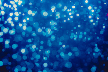 Abstract blue defocused bokeh of lights in dark